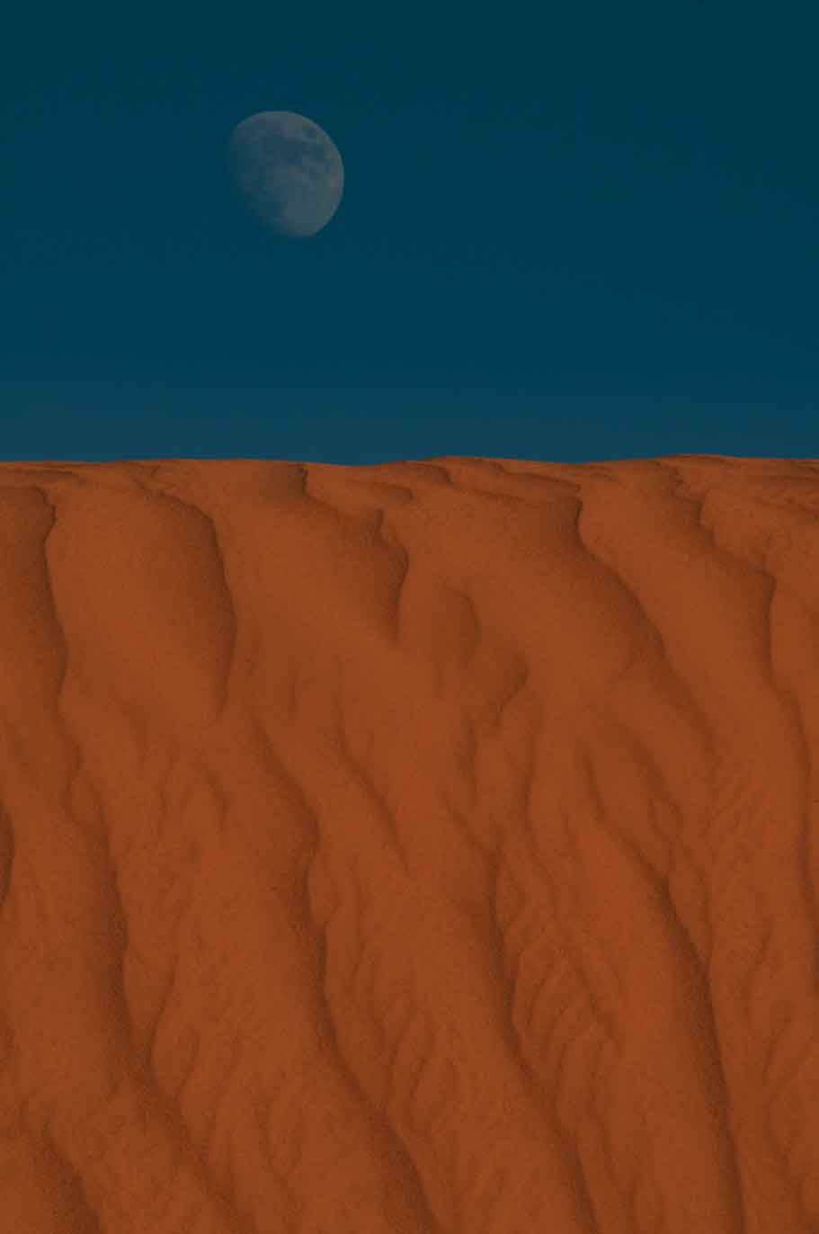 Full moon rising over a sand dune in the high desert near the Navajo community of Kaibito , Arizona
