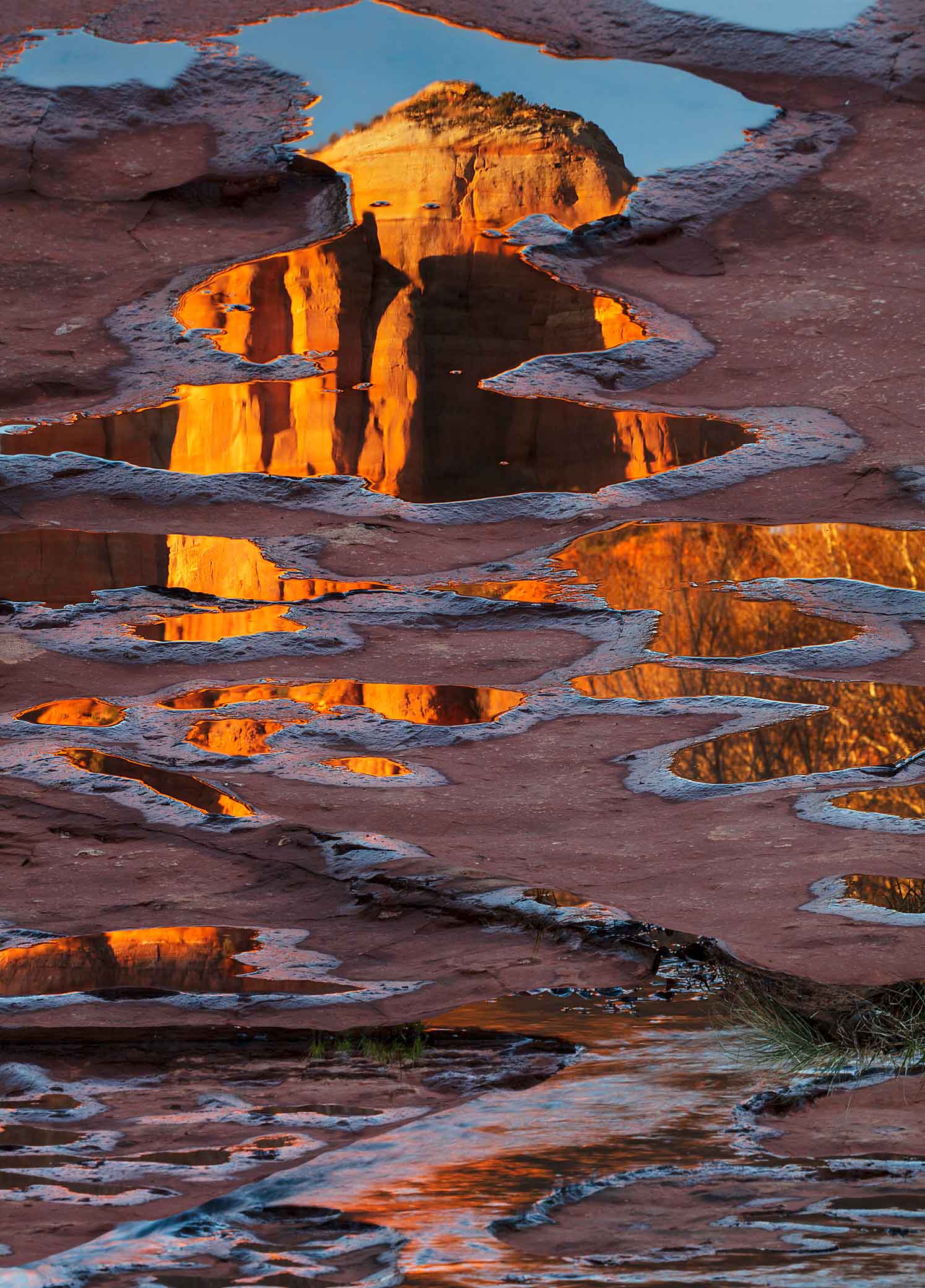 Cathedral Rock reflecting in puddles along Oak Creek, Arizona