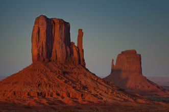 Sunset at East and West Mitten Buttes in Monument Valley on the Navajo Nation in northern Arizona.