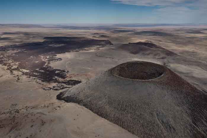 Drone photo of Arizona's SP Crater with a black basalt lava flow extenting more than four miles from the ancient volcano.
