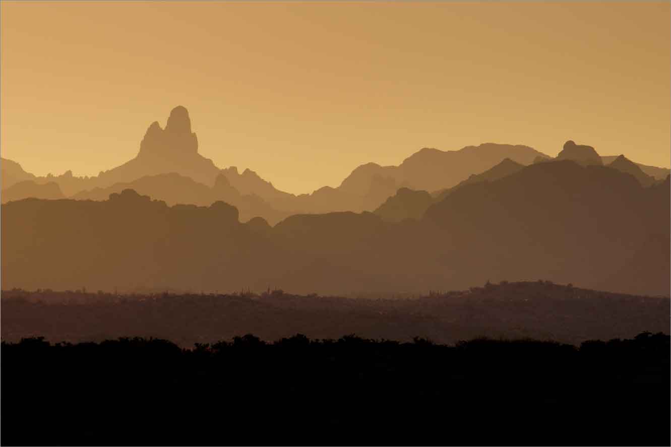 Arizona's Superstition Mts., including Weaver's Needle at left, as seen from the hills above the Town of Superior at sunset.